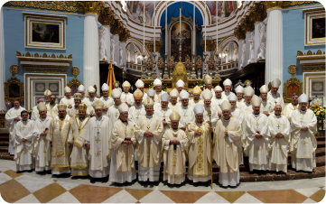 Group of clergy in white robes in a church