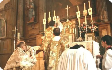 Priest performing Holy Mass with candles in background